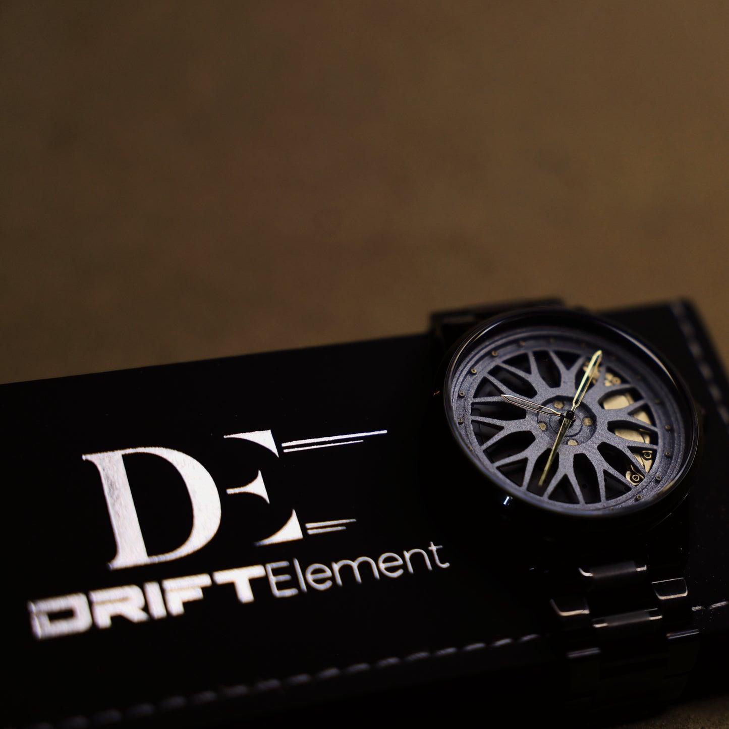 Image featuring the Final Edition watch by DriftElement, resting elegantly against its branded box. The watch showcases a unique, innovative rim design, highlighting the German startup's dedication to crafting timepieces with an automotive-inspired aesthetic.
